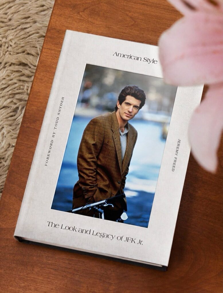 Hardcover book titled American Style featuring JFK Jr. in a brown blazer on wood.
