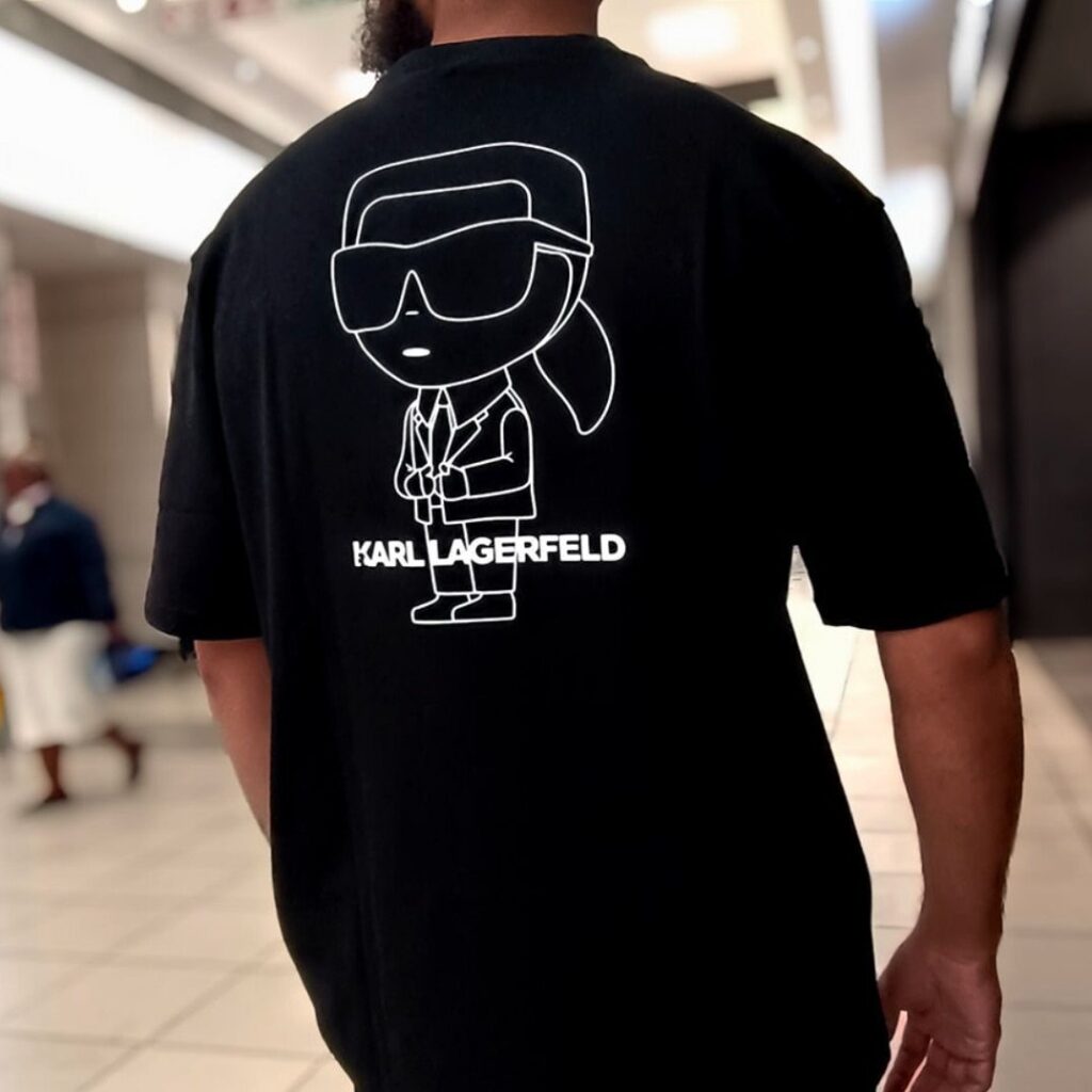 Black t-shirt with a white Karl Lagerfeld graphic on the back worn by a man.